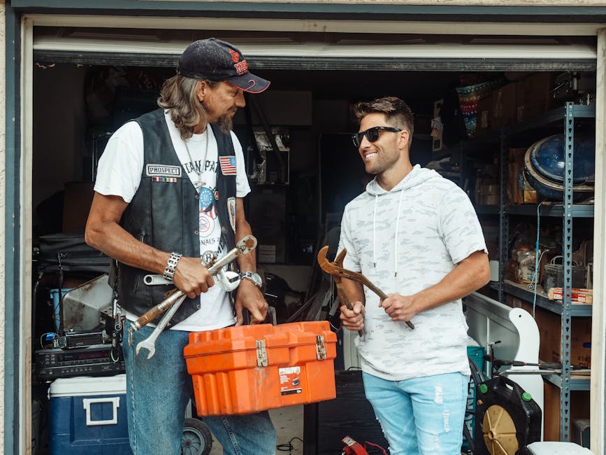 A father and son enjoy bonding time in the garage, working with tools.